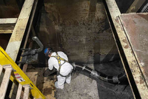 vacuuming sludge from a sump pit